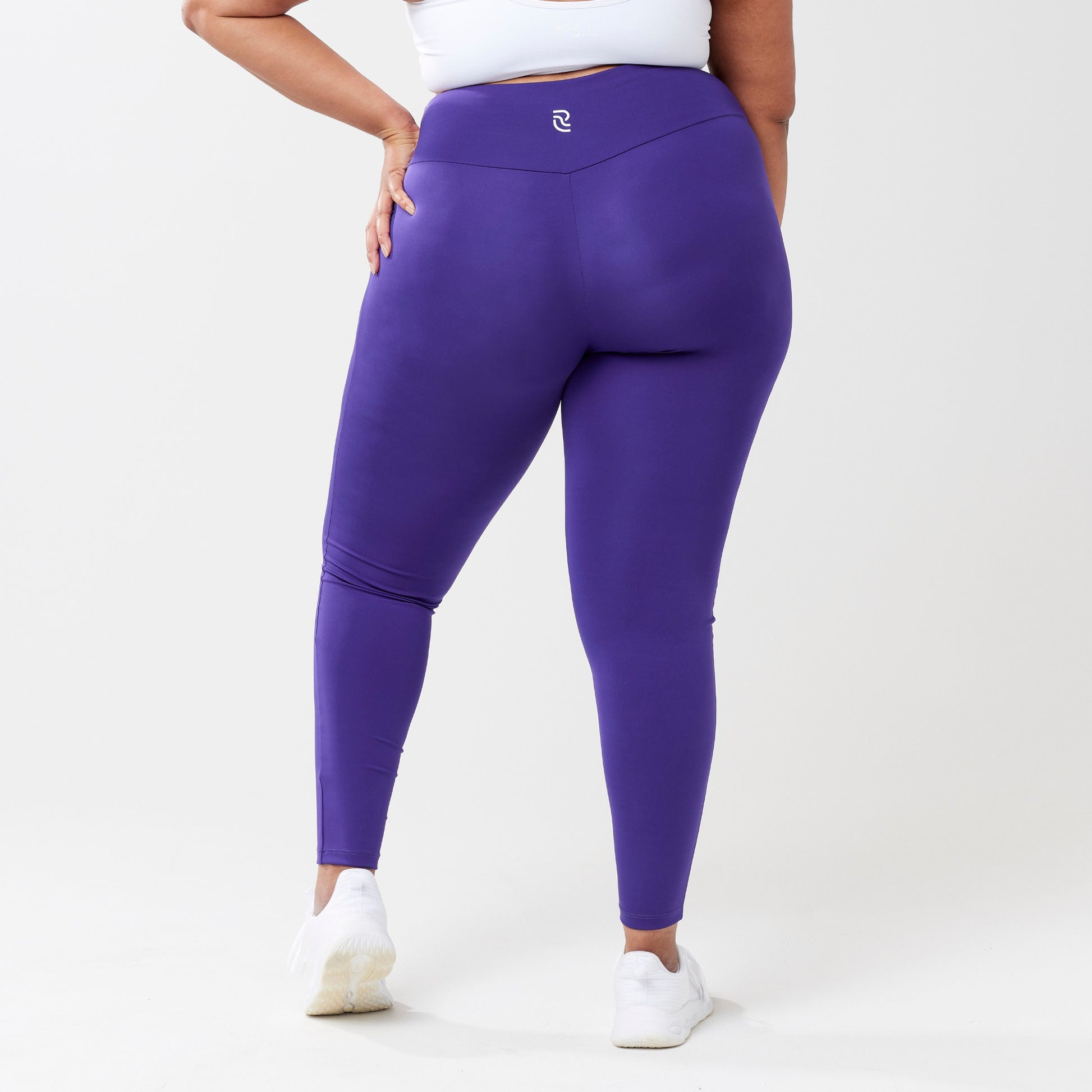 Plus model wearing indigo leggings for use in active lifestyles as well as casual living.