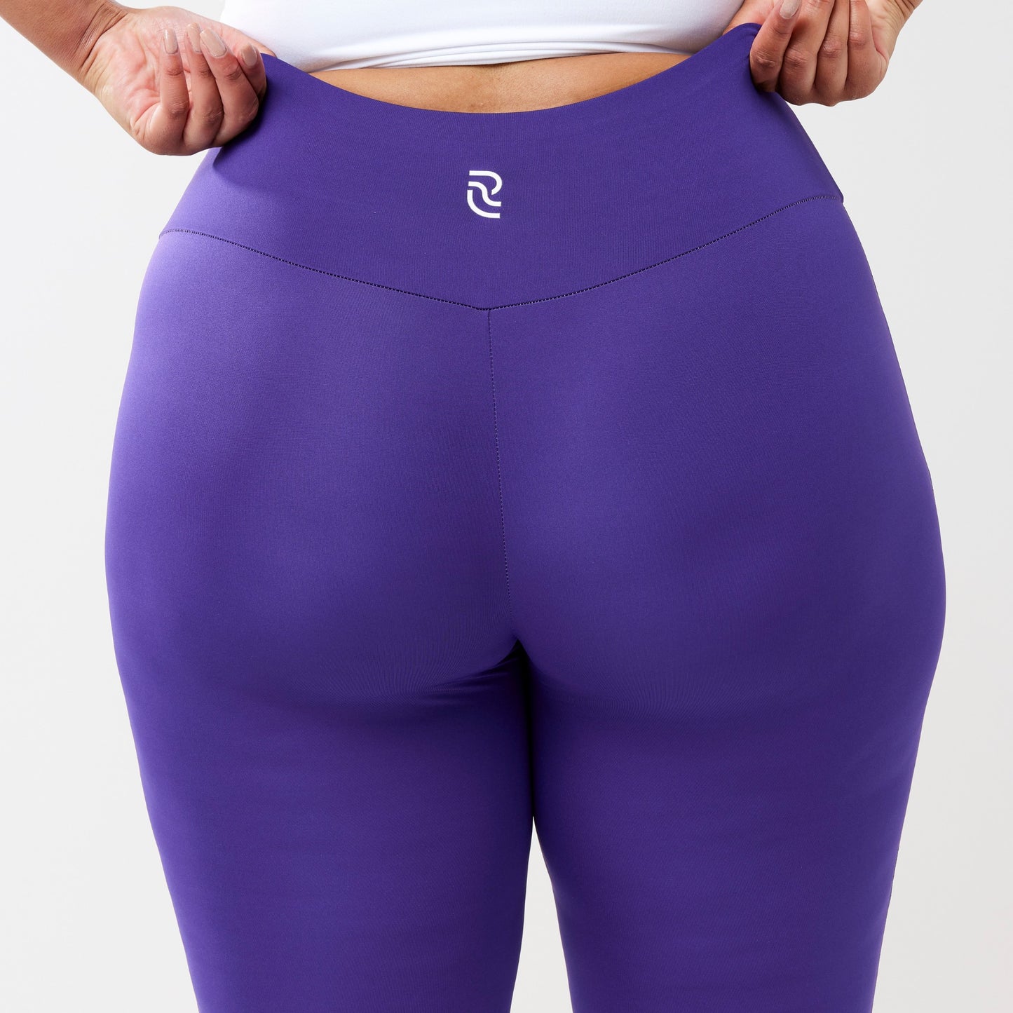 Plus model wearing indigo leggings for use in active lifestyles as well as casual living.