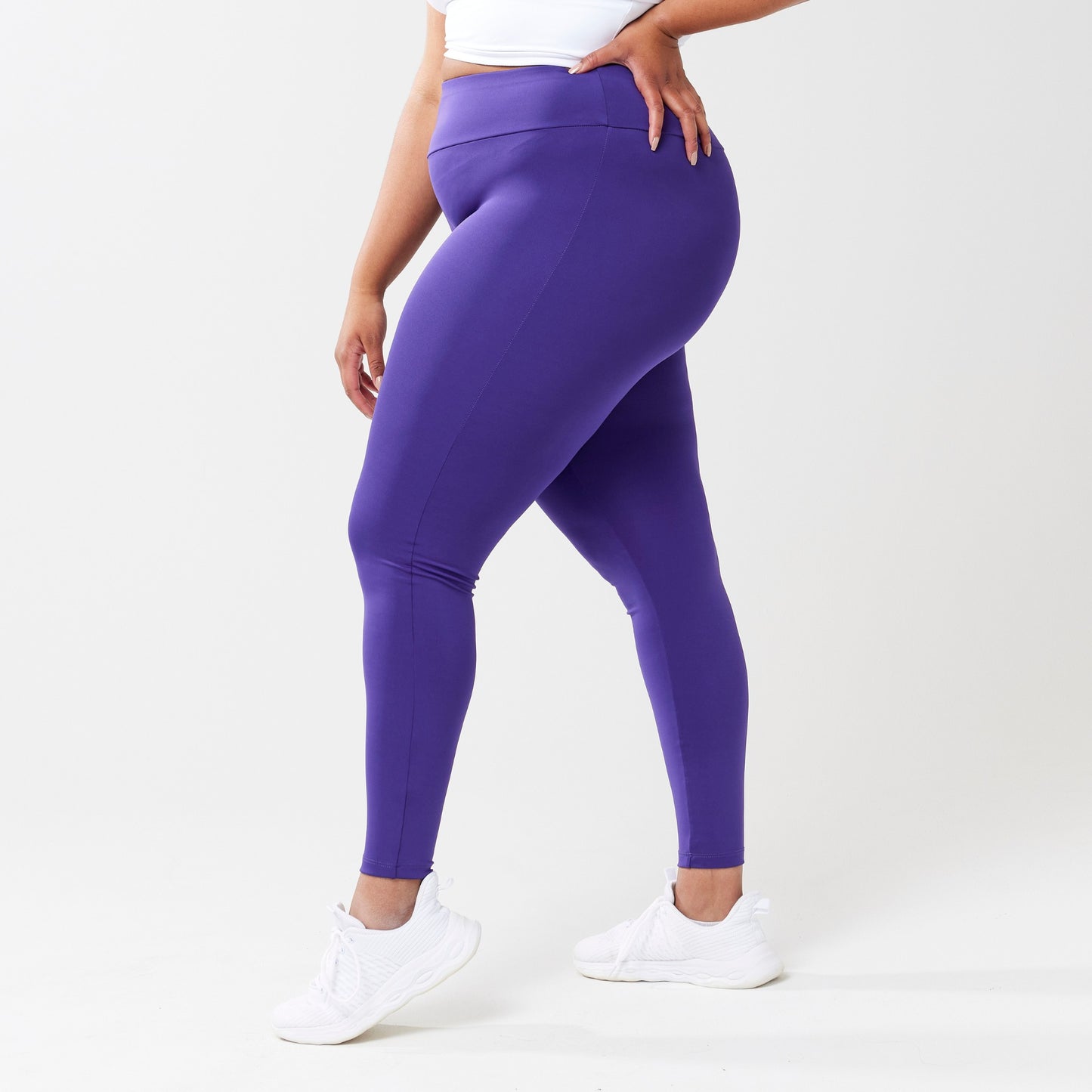 Plus model wearing indigo leggings for use in active lifestyles as well as casual living.