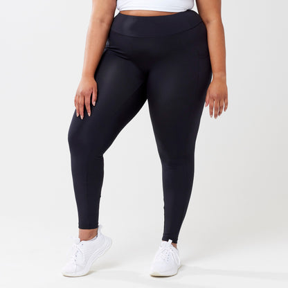 Plus model wearing black leggings for use in active lifestyles as well as casual living.