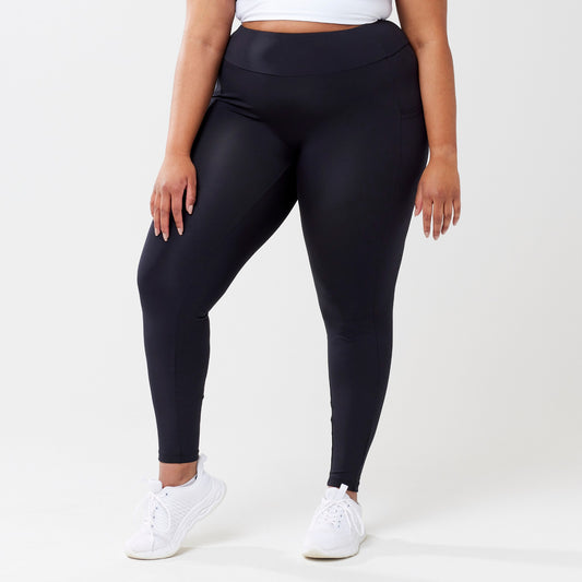 Plus model wearing black leggings for use in active lifestyles as well as casual living.