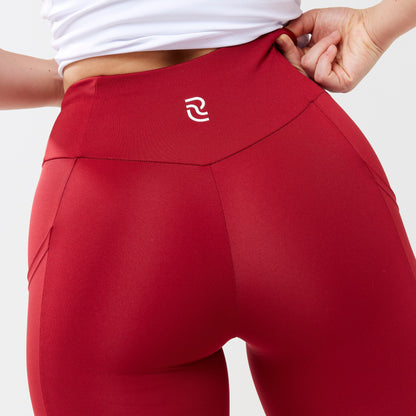 Model wearing red leggings for use in active lifestyles as well as casual living.