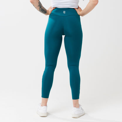 Model wearing rich teal leggings for use in active lifestyles as well as casual living.