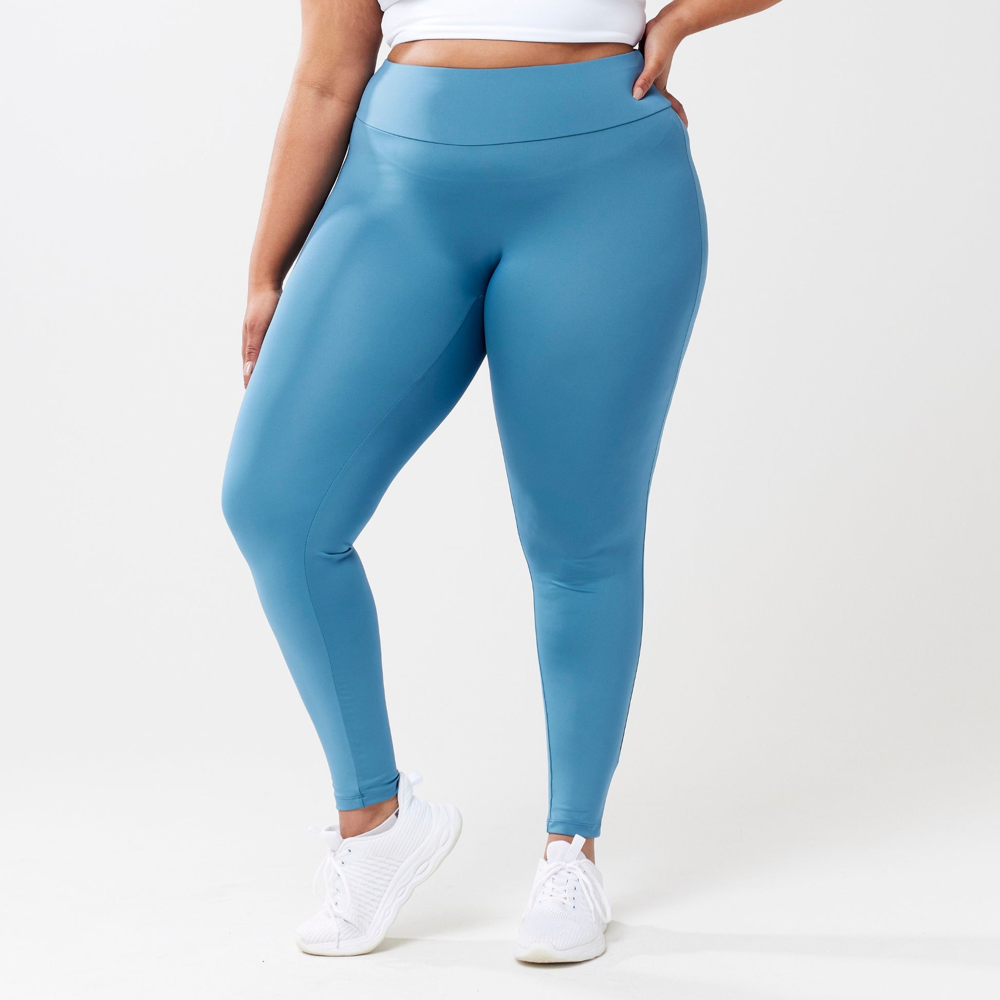 Plus sized model wearing sky blue leggings for use in active lifestyles as well as casual living.