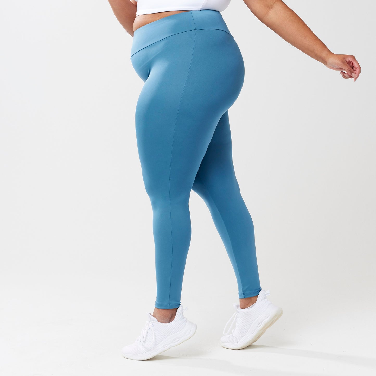 Plus sized model wearing sky blue leggings for use in active lifestyles as well as casual living.